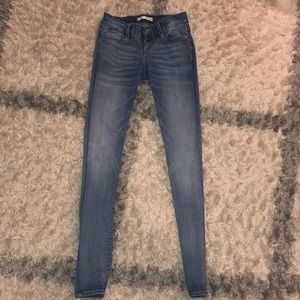 Skinny, medium rise, light wash blue jeans.